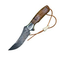 A fixed-blade knife with a patterned Damascus steel blade, a brown wooden handle, and an orange-brown lanyard, displayed diagonally on a solid green background.